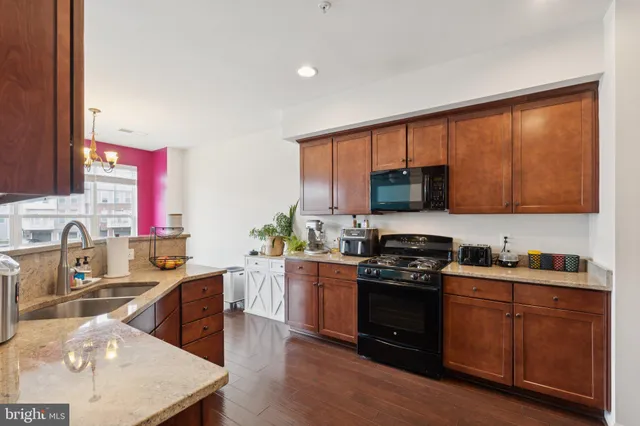 a kitchen with a sink a stove and cabinets