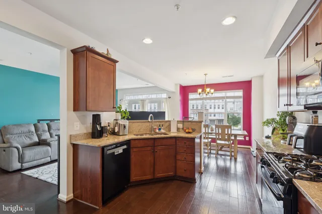 a kitchen with lots of counter top space and wooden floor