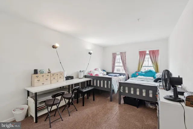 a view of a workspace with furniture and window