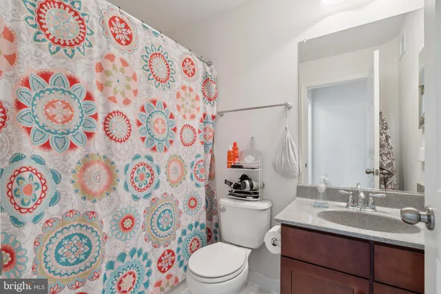 a bathroom with a toilet sink and mirror with painted walls