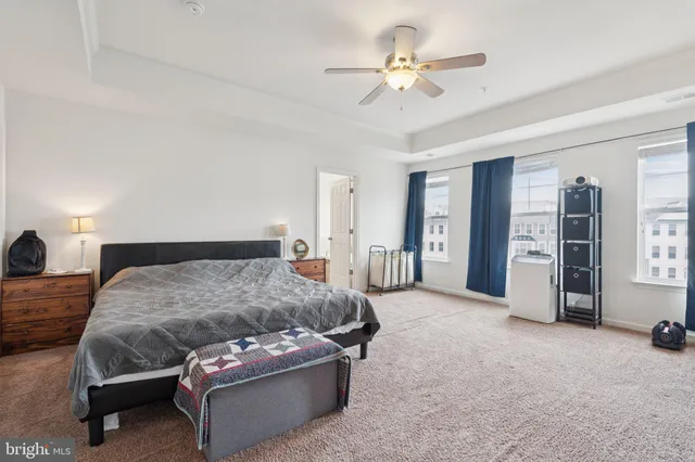 a bedroom with a bed a chandelier and closet