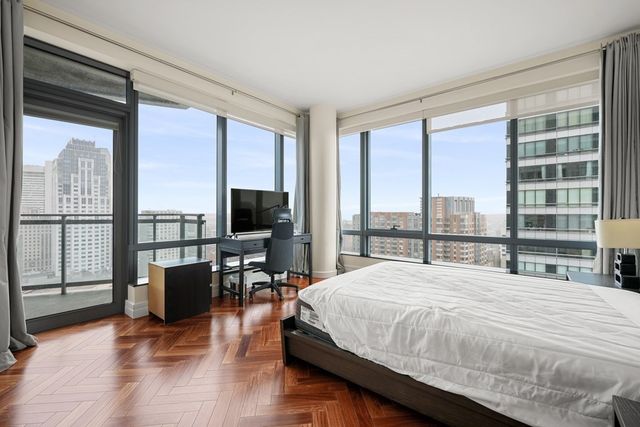 a bedroom with a large window and a bed