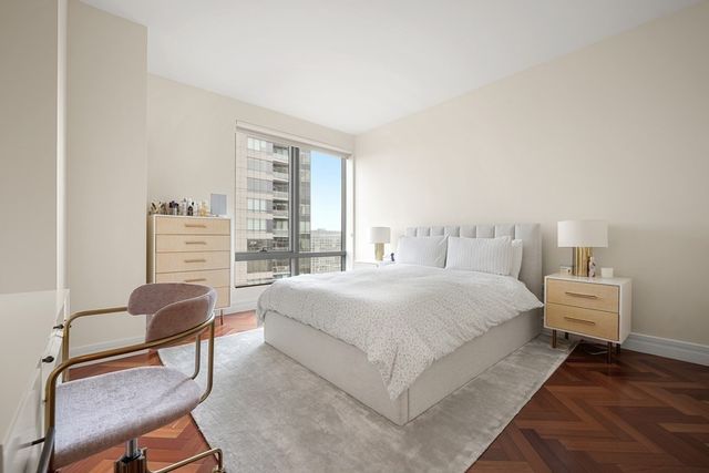 a bed room with a bed and chair