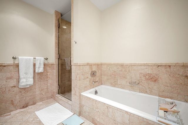 a bathroom with a bathtub and shower