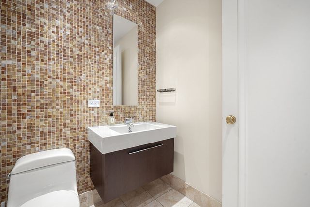 a bathroom with a sink a toilet and mirror