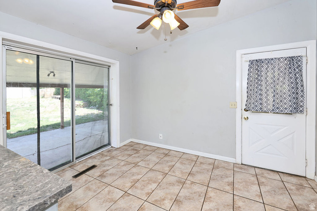 1272 Cook Street Ogden, UT 84404 - Photo 14 of 46 Tiled flooring with sliding glass door access to a patio and backyard