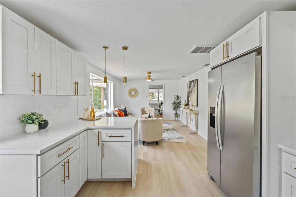 17 Palmira Road DeBary, FL 32713 - Photo 12 of 28 a kitchen with white cabinets and stainless steel appliances