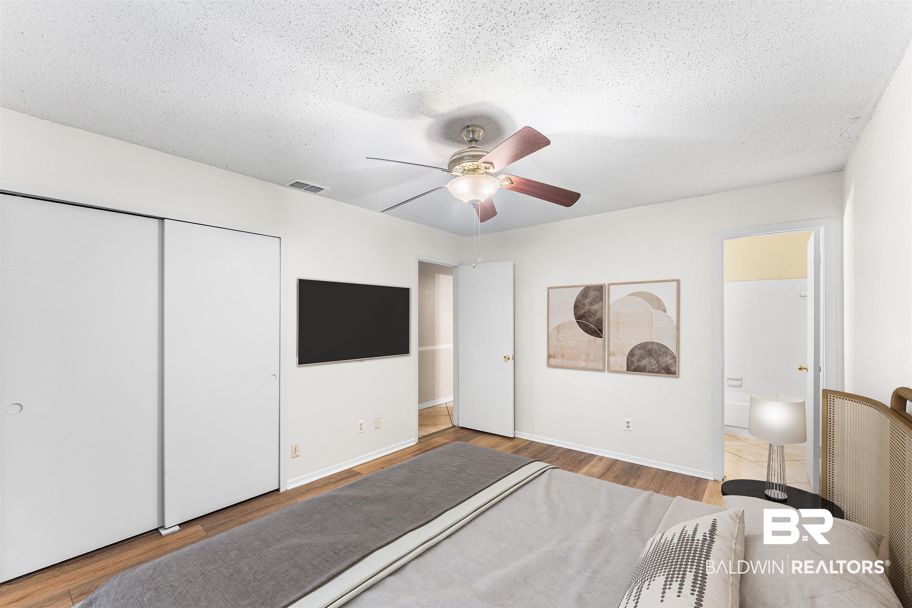 5551 Springer Court Theodore, AL 36582 - Photo 7 of 37 Bedroom with ceiling fan, a textured ceiling, light wood finished floors, and a closet