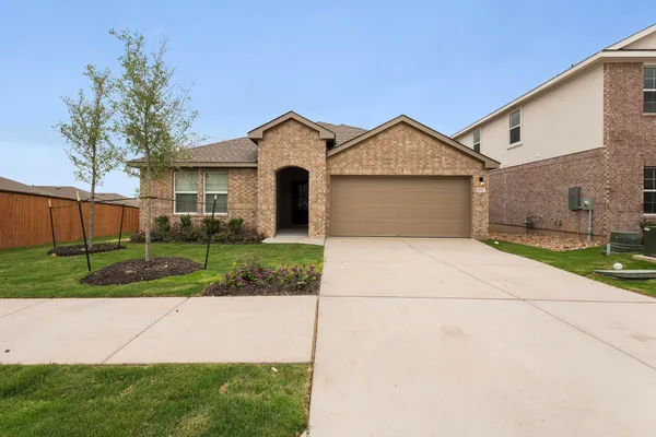 a front view of a house with yard and garage