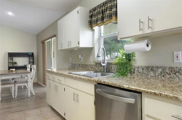 a kitchen with a sink and cabinets
