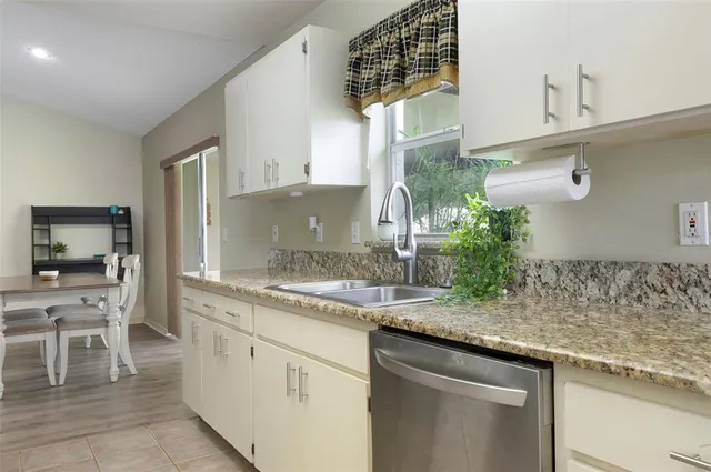 a kitchen with a sink and cabinets