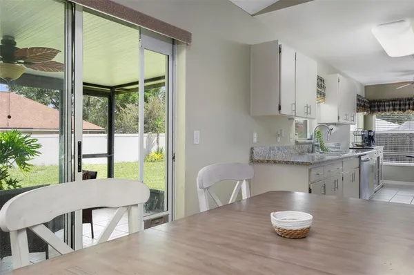 a kitchen with a table and chairs