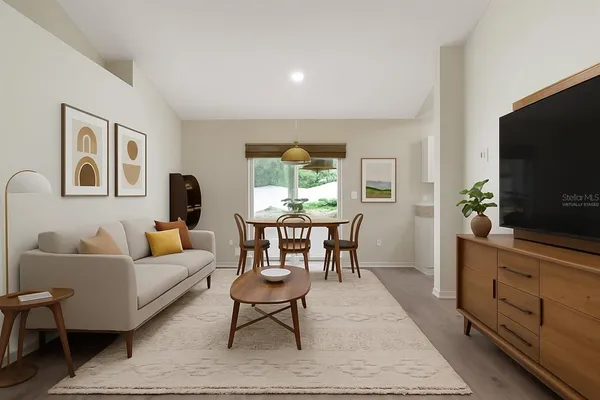 a living room with furniture a window and a flat screen tv