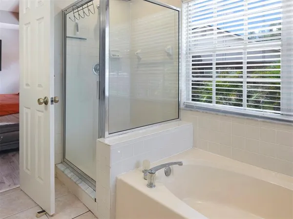 a white bath tub sitting next to a window