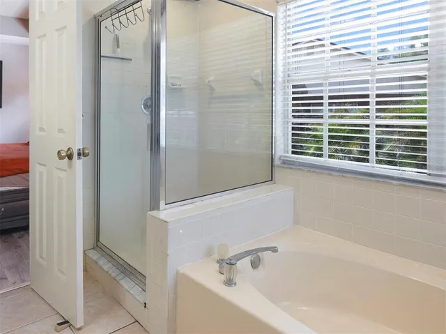 a white bath tub sitting next to a window