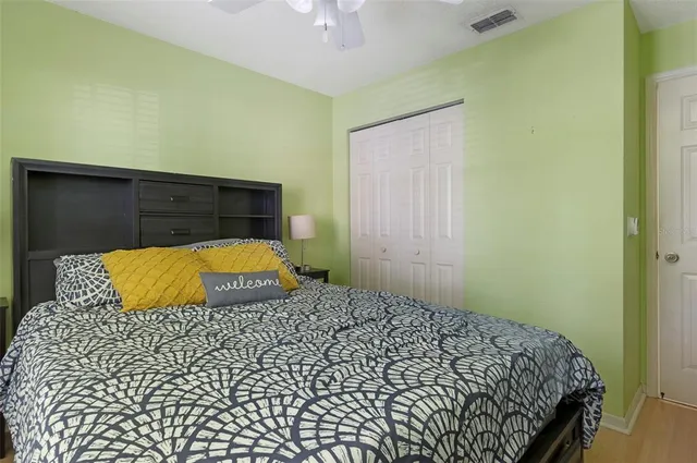 a bedroom with a bed and a lamp