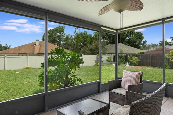 a view of a porch with furniture and a yard