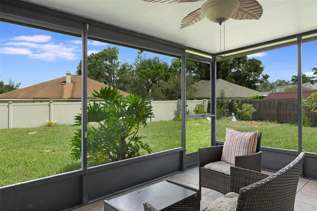 a view of a porch with furniture and a yard