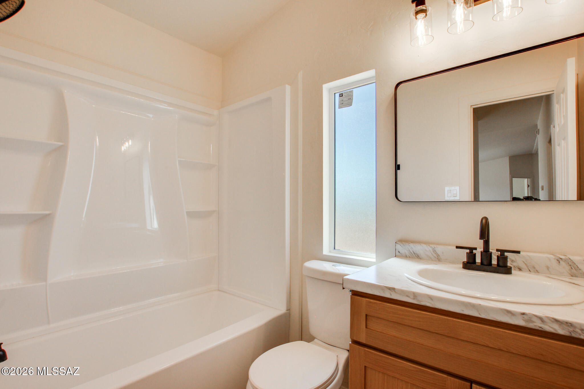 14303 West Rolina Lane Tucson, AZ 85736 - Photo 18 of 38 a bathroom with a sink toilet a mirror and bathtub