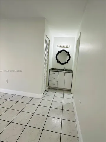 a bathroom with a granite countertop sink a mirror and a shower