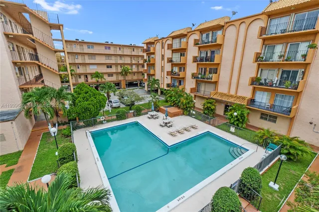 a view of a residential apartment building with a yard