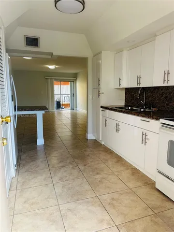 a kitchen with granite countertop a stove a sink and a granite counter tops