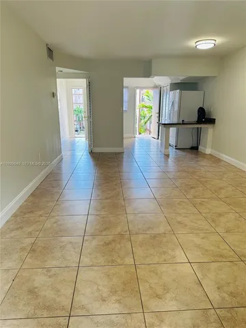 a view of hallway with a window and chandelier