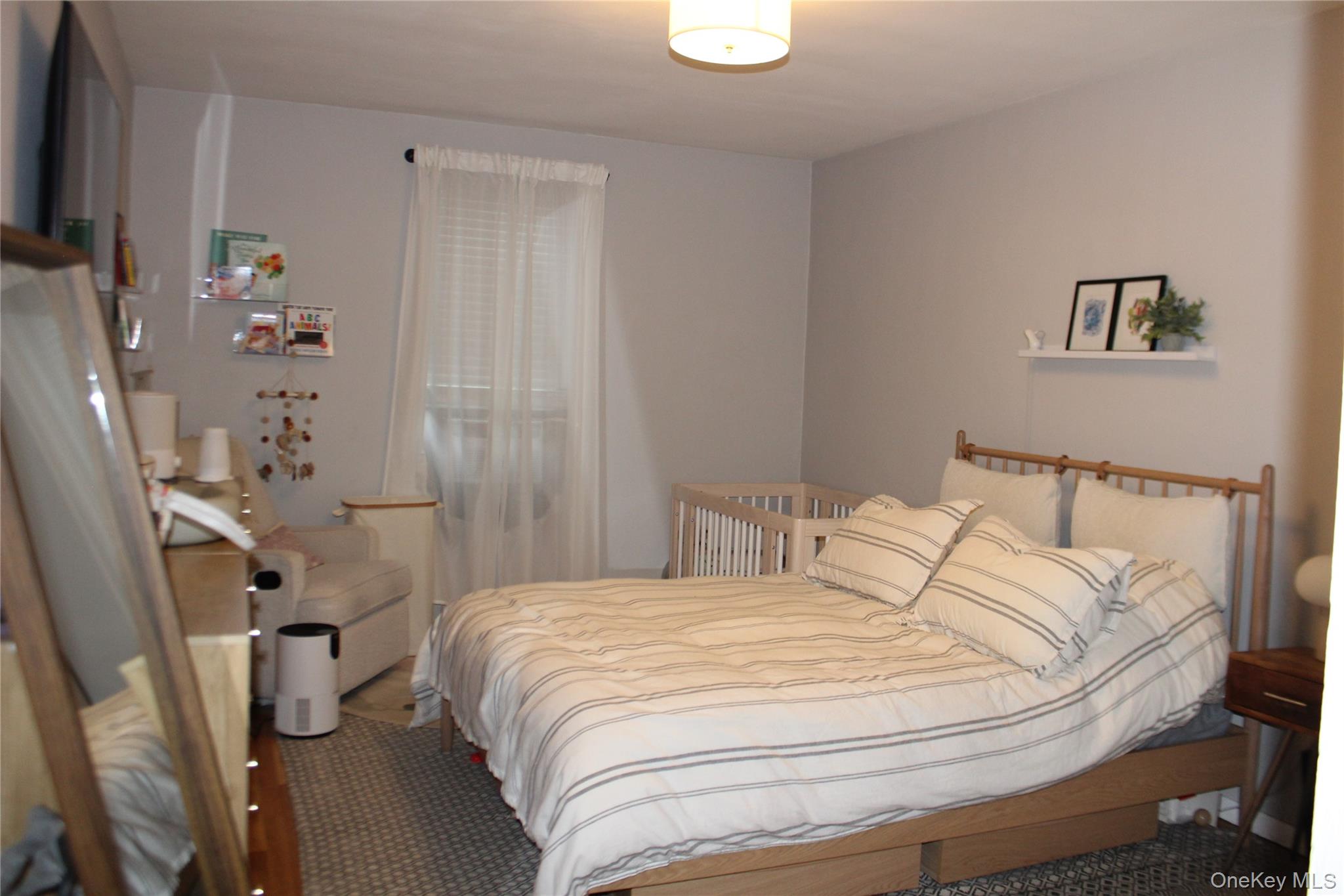 4315 Webster Avenue, Unit 3B Bronx, NY 10470 - Photo 5 of 13 a bedroom with a bed and a flat screen tv