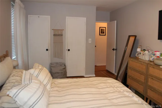 a bedroom with a bed and a dresser in it