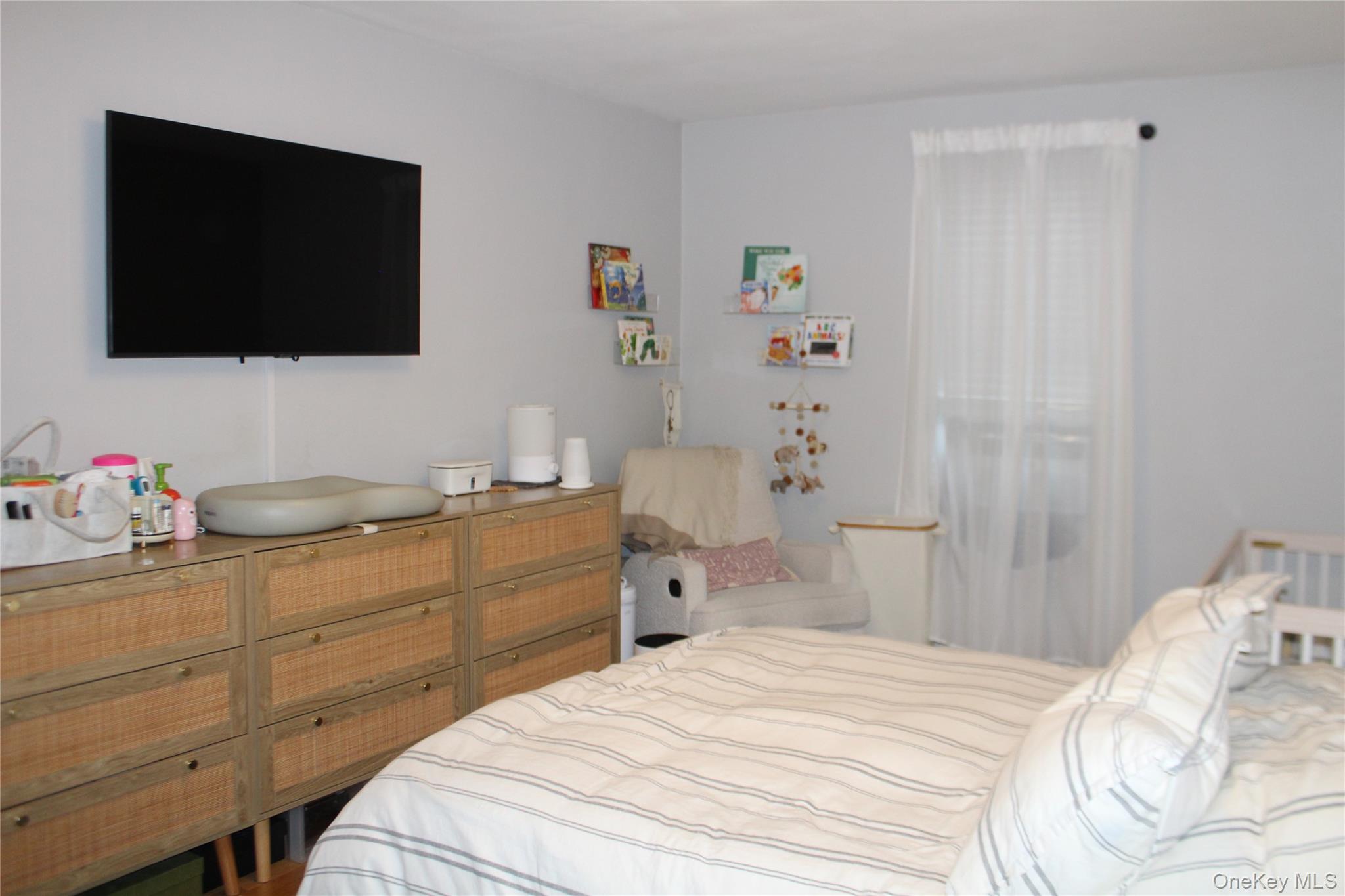 4315 Webster Avenue, Unit 3B Bronx, NY 10470 - Photo 7 of 13 a bedroom with a bed and a flat screen tv