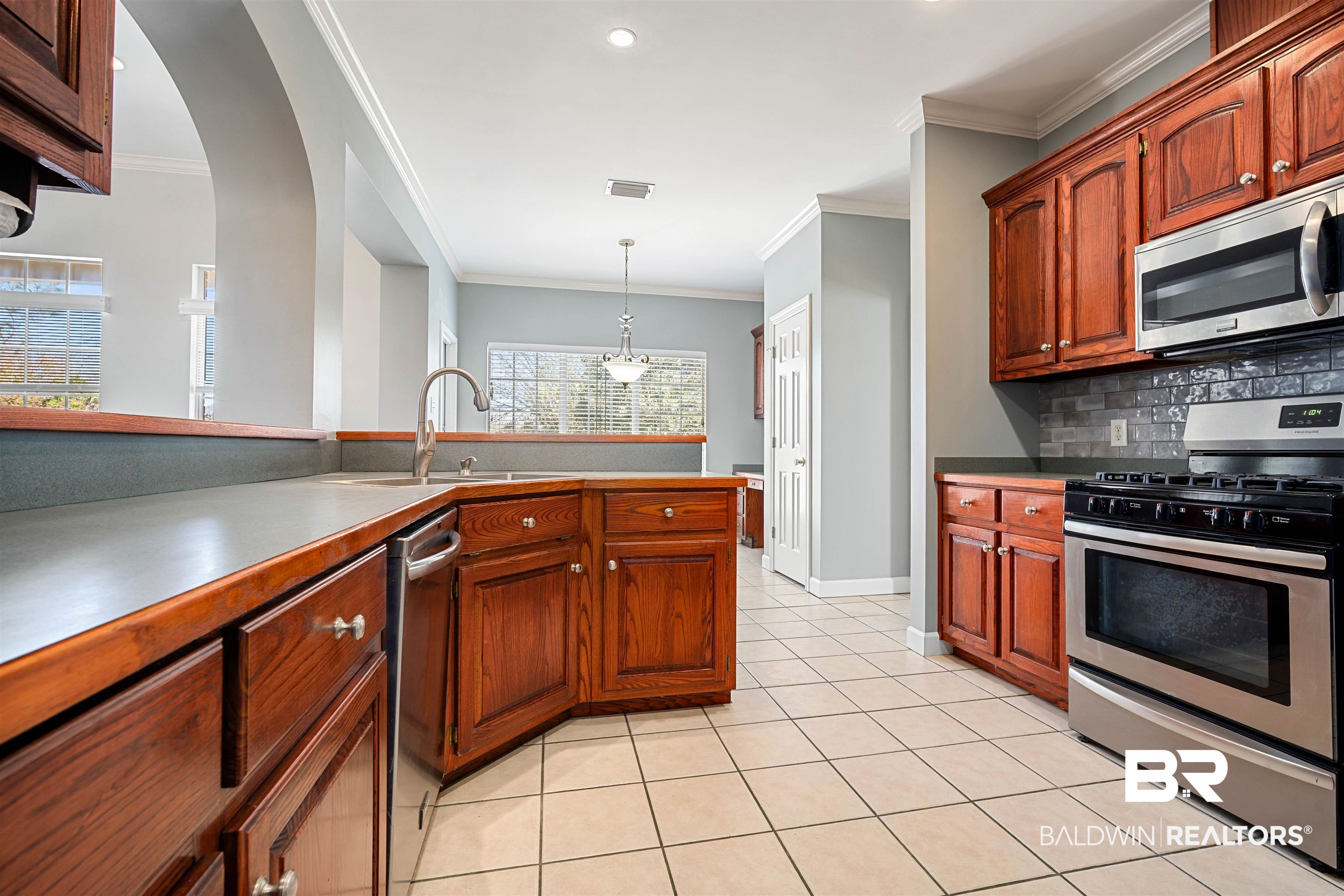 615 Summerlake Place Mobile, AL 36608 - Photo 11 of 35 Kitchen featuring stainless steel appliances, ornamental molding, decorative light fixtures, light tile patterned floors, and recessed lighting