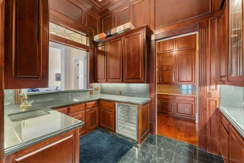 a kitchen with stainless steel appliances granite countertop a sink stove and cabinets