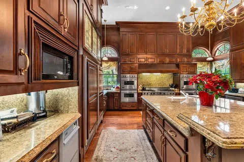 a kitchen with stainless steel appliances a sink and wooden cabinets