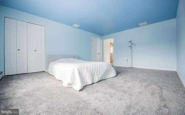 a bed room with a bed and a night stand