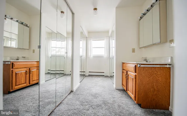 a view of a kitchen with stainless steel appliances granite countertop a refrigerator and a stove