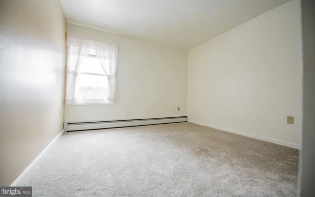 an empty room with a empty space and a window