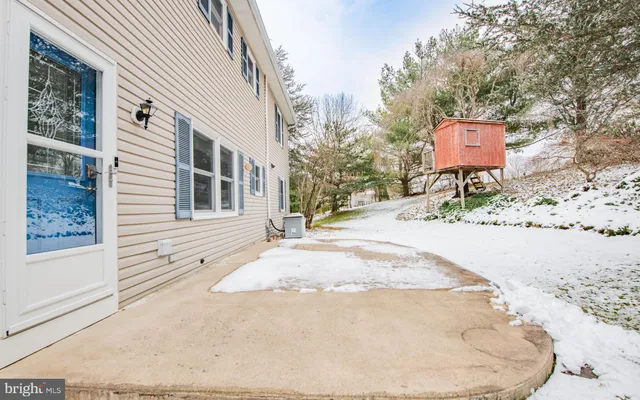 a view of a house with a snow on the road