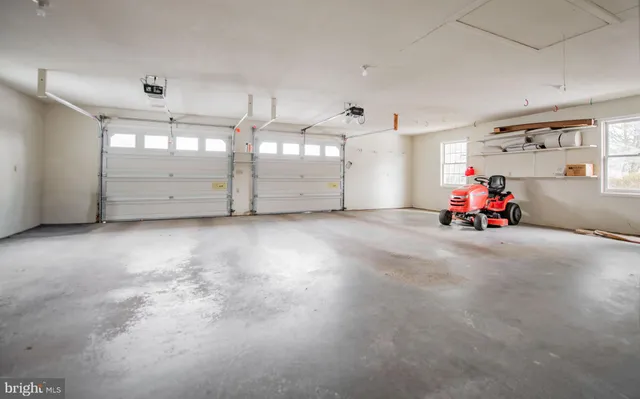 a front view of a house with a yard covered in snow