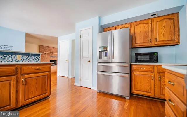 a kitchen with stainless steel appliances granite countertop a refrigerator and microwave