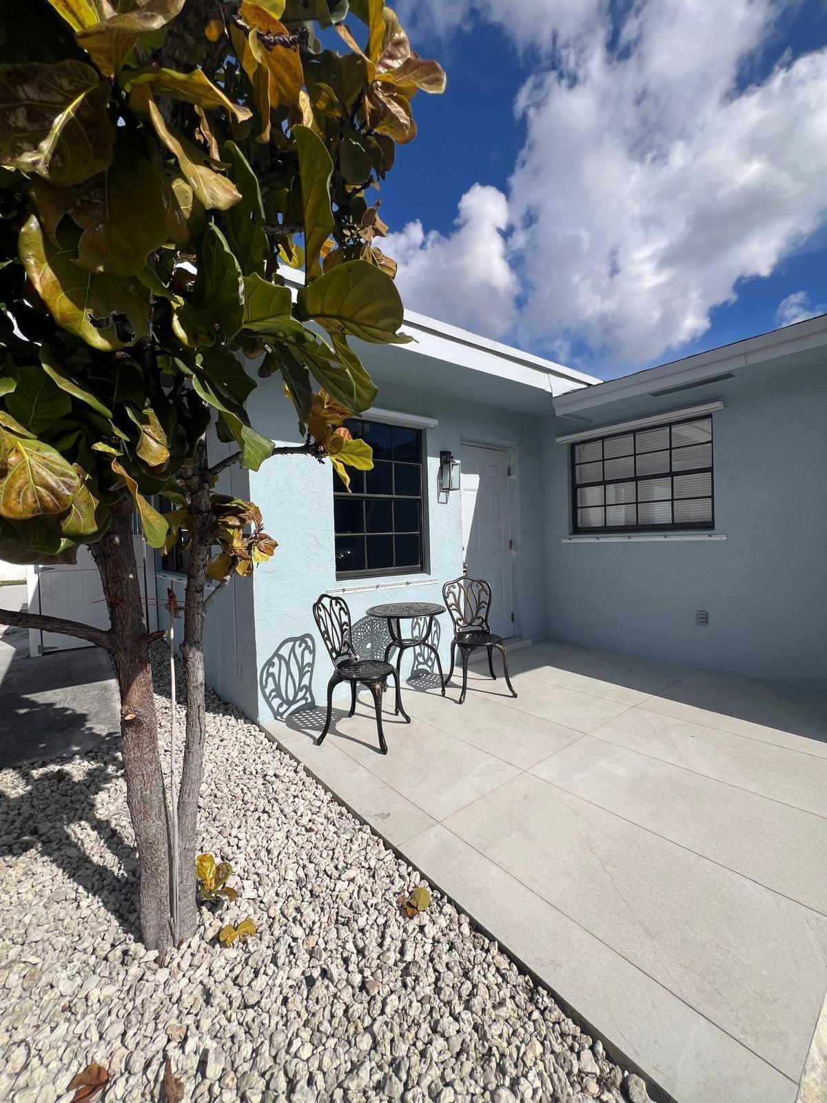 a view of a patio with a table and chairs