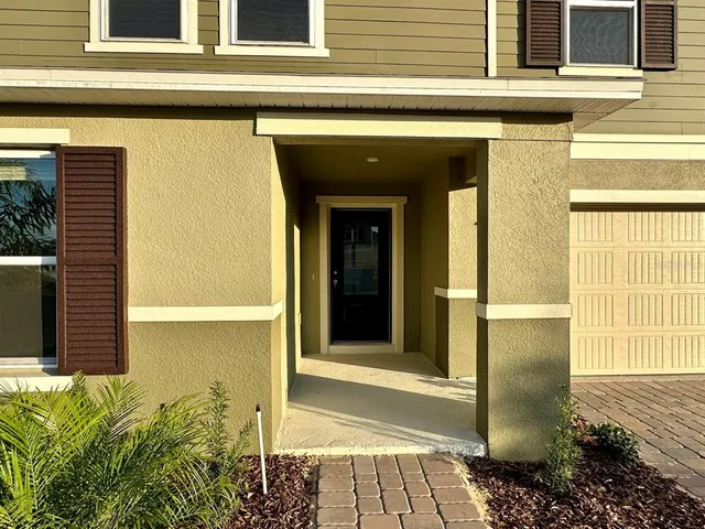 a view of a house with a door and a chair