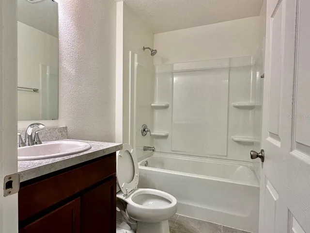 a bathroom with a sink a toilet and a bathtub