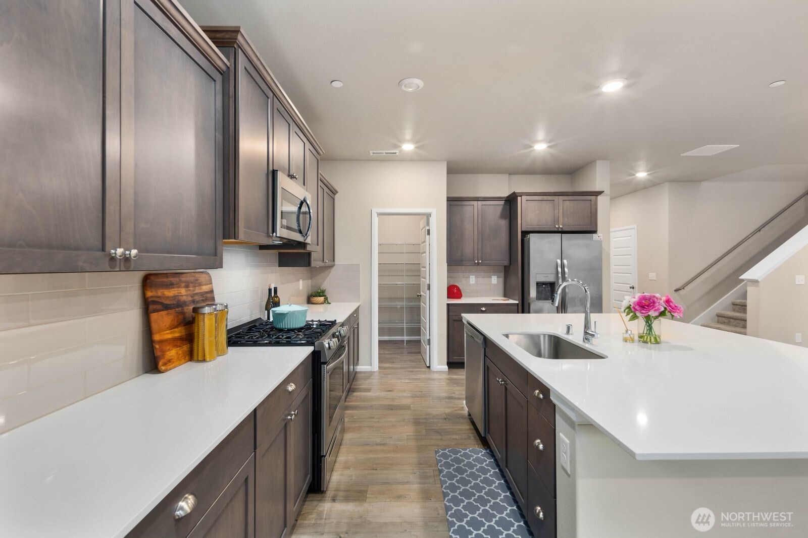 1214 Baker Hts Loop Bremerton, WA 98312 - Photo 12 of 38 a kitchen with a sink a counter top space stainless steel appliances and cabinets