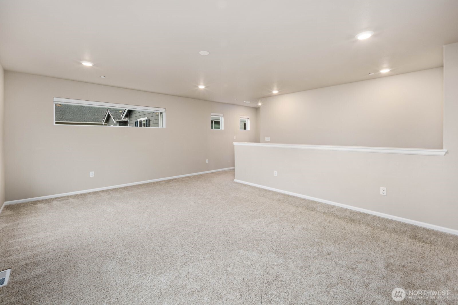 1214 Baker Hts Loop Bremerton, WA 98312 - Photo 17 of 38 a view of a big room with wooden floor and windows