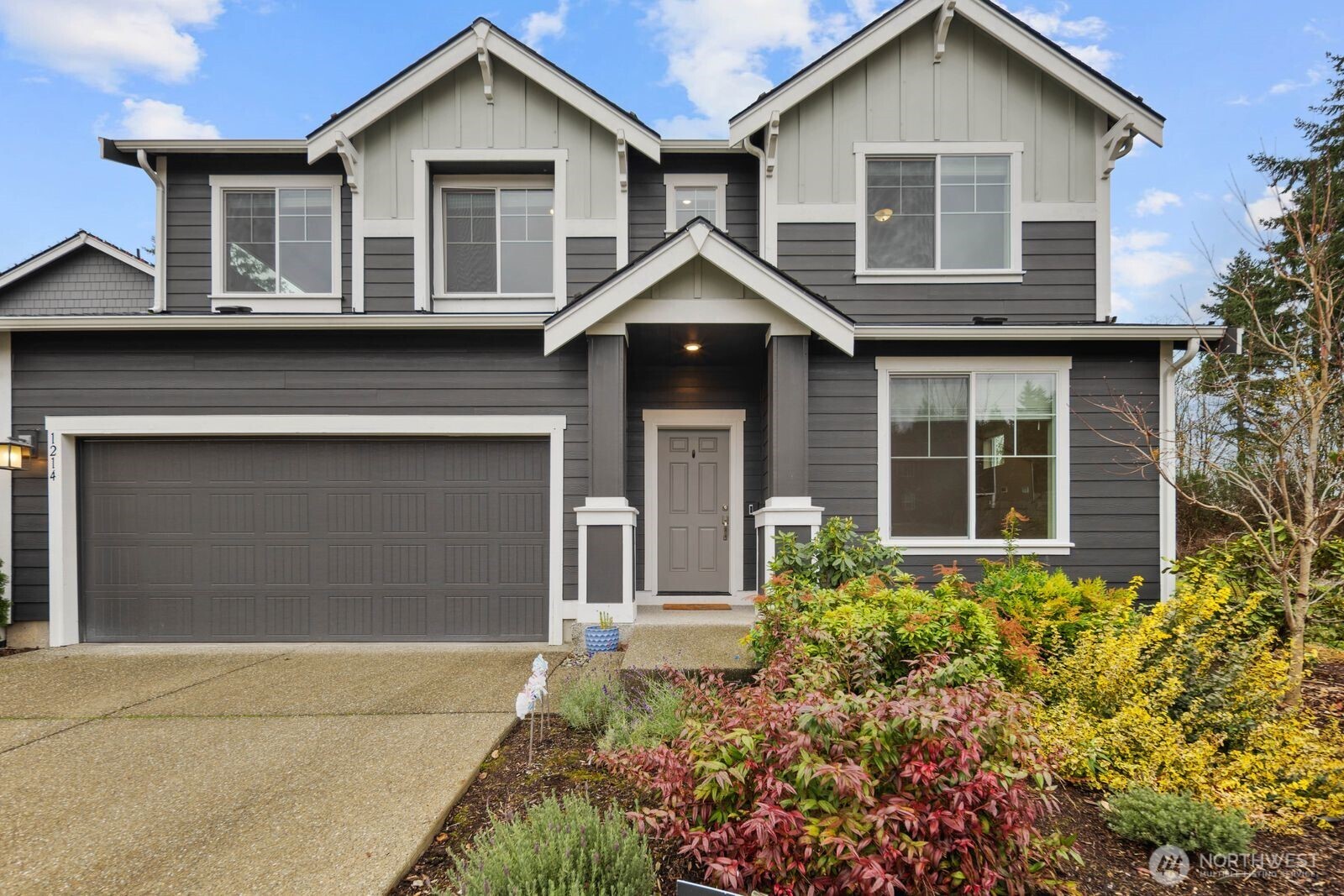1214 Baker Hts Loop Bremerton, WA 98312 - Photo 2 of 38 a front view of a house with a yard and garage