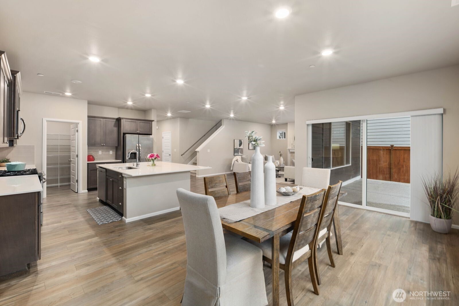 1214 Baker Hts Loop Bremerton, WA 98312 - Photo 9 of 38 a kitchen with a dining table chairs and wooden floor