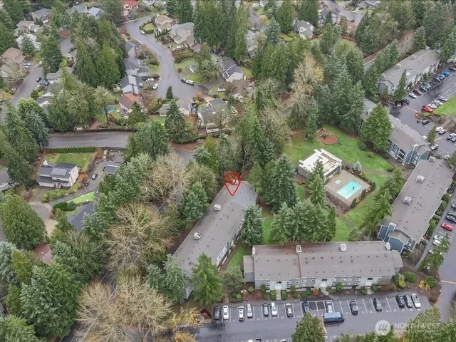 an aerial view of a house with a yard and lake view