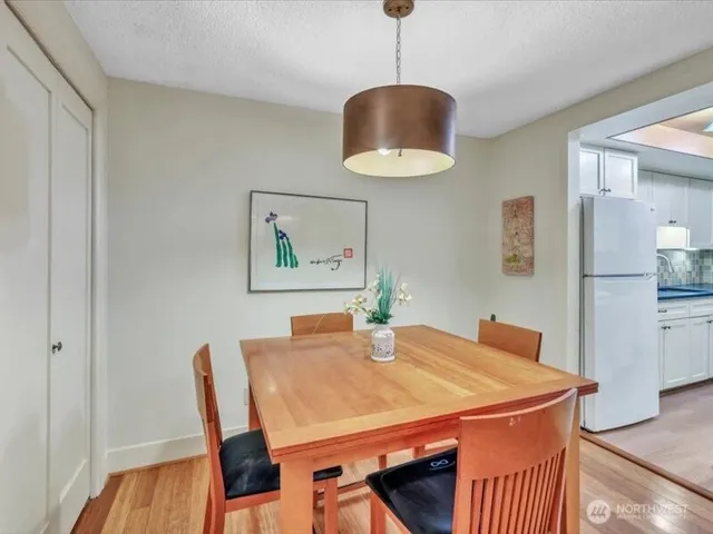 a dining room with furniture and wooden floor