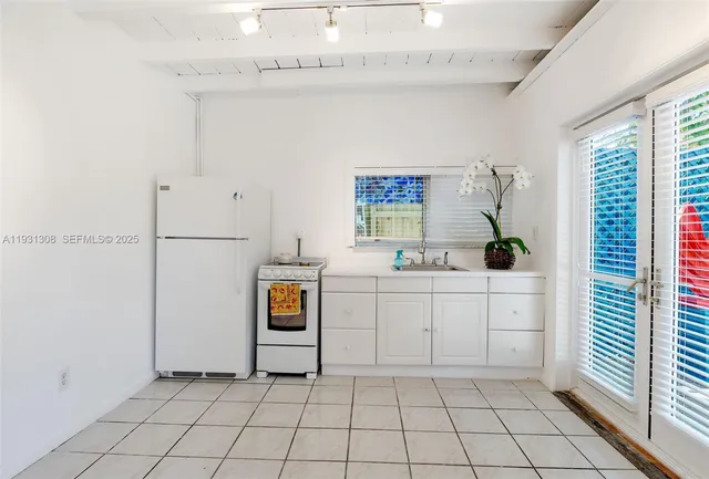 a utility room with cabinets washer and dryer