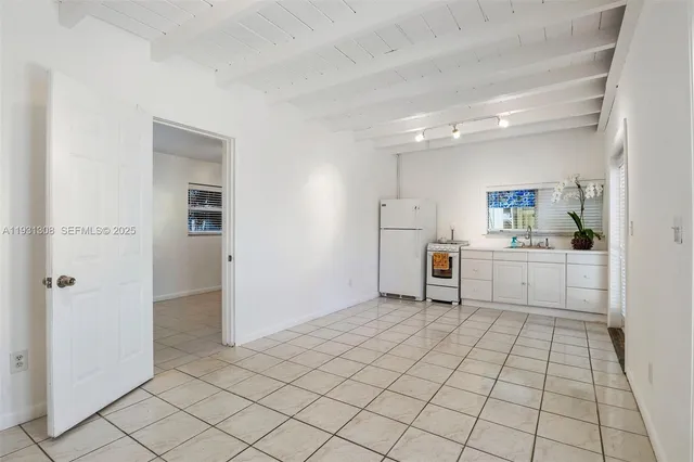a view of a kitchen with white cabinets